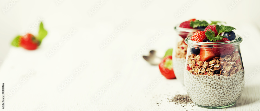  Сhia seeds vanilla pudding and berries on wooden rustic backgr