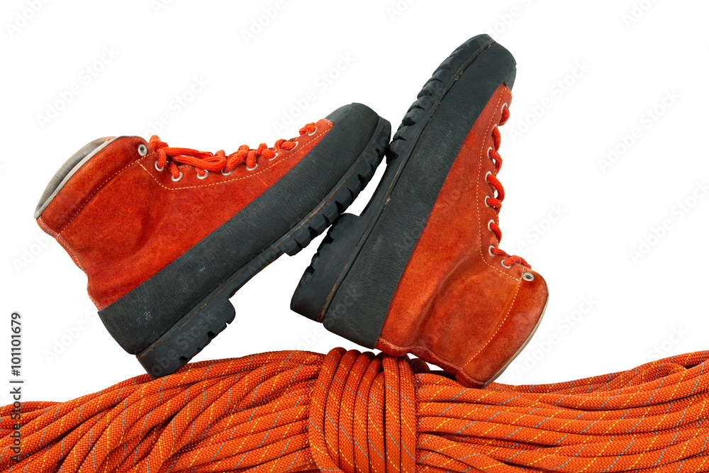 Mountaineering Boots and Rope / Rock climbing equipment with a pair of mountaineering boots and a red rope. Isolated on white background Mountaineering Boots and Rope / Rock climbing equipment with a pair of mountaineering boots and a red rope. Isolated on white background