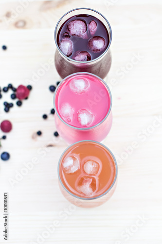 Fresh colorful lemonade (pink, purple, orange) in glasses