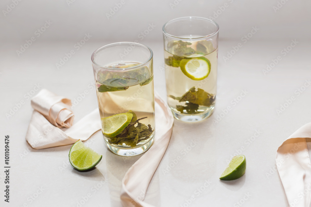 Green tea in a glass with lime and cookies on a plate Green tea in a glass with lime and cookies on a plate