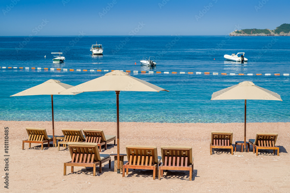 Sand beach with wooden furniture and perfect Adriatic sea