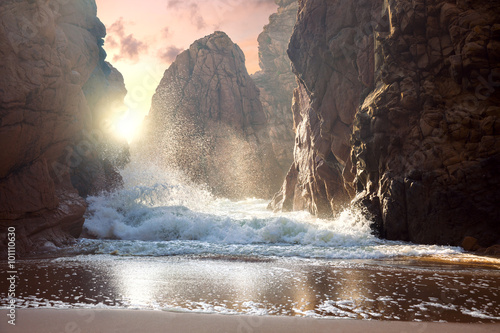 Fototapeta Naklejka Na Ścianę i Meble -  Fantastic big rocks and ocean waves at sundown time. Dramatic