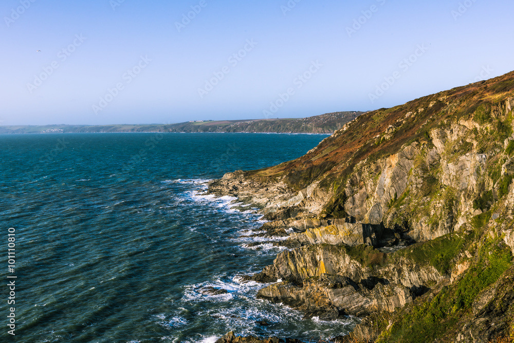 Rocky coastline and ocean waves in Cornwall, UK