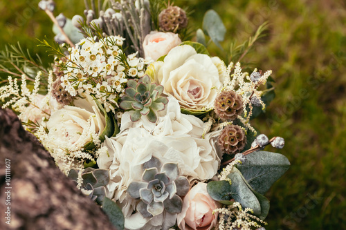 Принти на полотні wedding bouquet with roses and succulents on green grass and woo