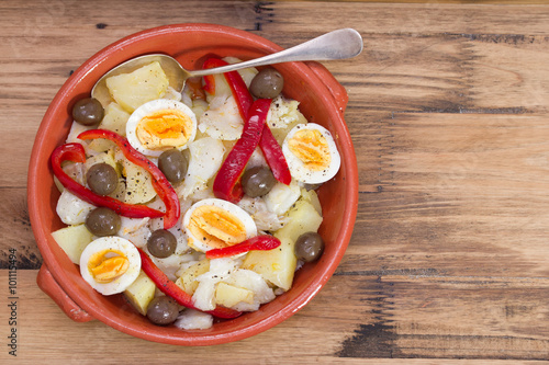 traditional portuguese dish on ceramic plate on brown background