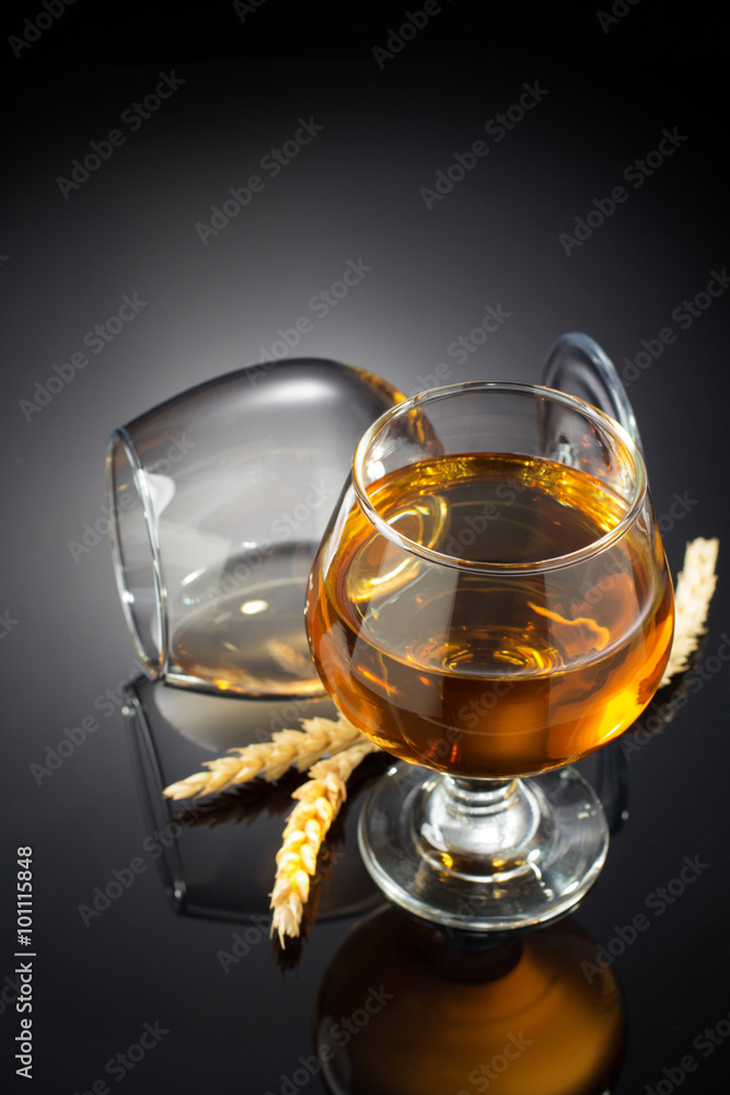 cognac and  glass  on black