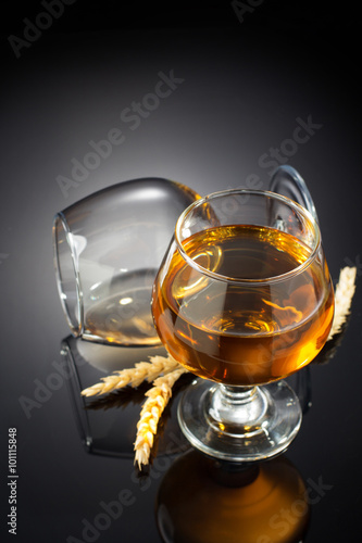 cognac and glass on black