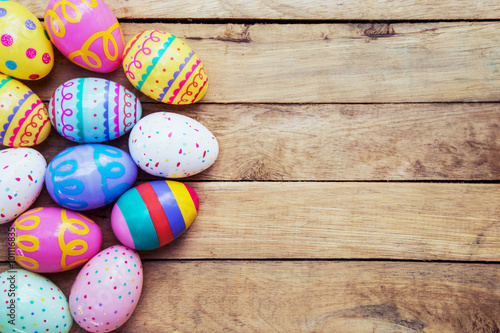 Easter eggs on wooden background with space