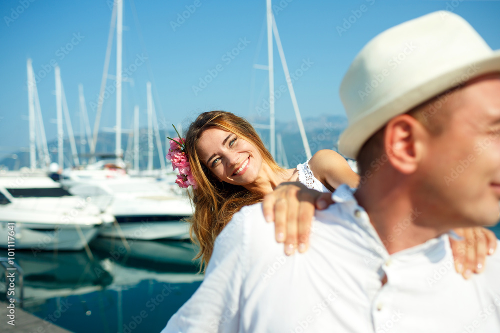 Attractive young couple walking alongside the marina - wedding c