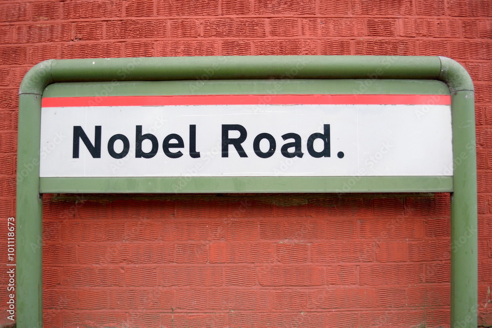 Fototapeta premium Nobel Road sign against wall made of red bricks in London, England