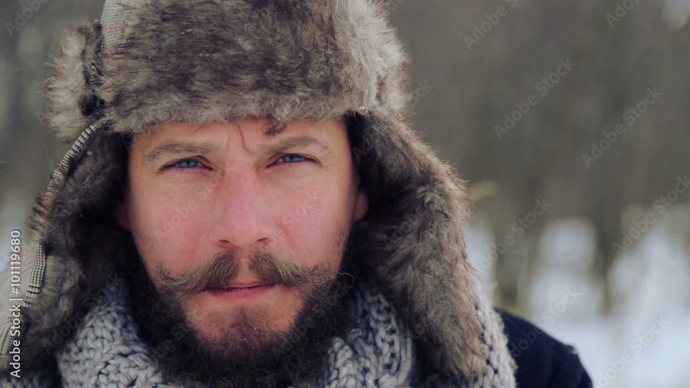 Portrait of a bearded man with an apple in the winter. A young bearded man eats an apple in the winter.
Portrait of a bearded man with an apple in the winter. A young bearded man eats an apple in the winter.