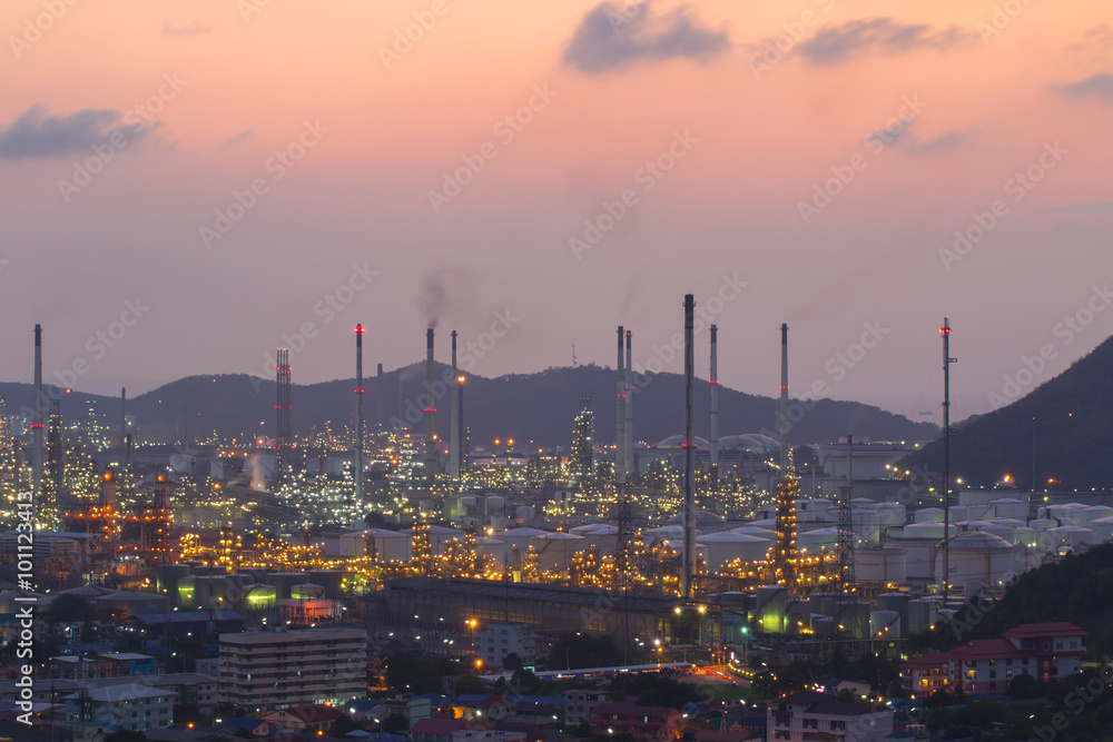 Oil refinery with water vapor in Hamburg, Germany, petrochemical industry during twilight.