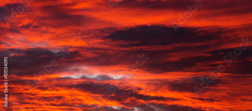 Beautiful orange sunset with dark clouds © Marina P.