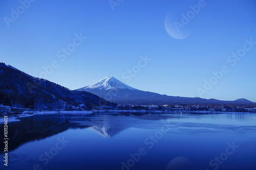 Beautiful scenery of the moon on morning sky at Mountain Fuji in kawaguchiko lake.