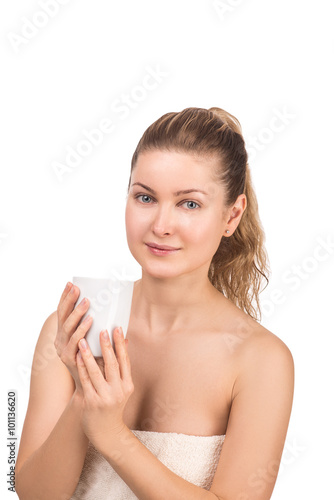 beautiful young woman on white background in towel with cup of tea