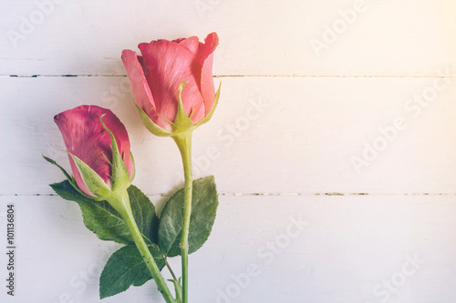 Overhead view of beautiful roses on wood table photo