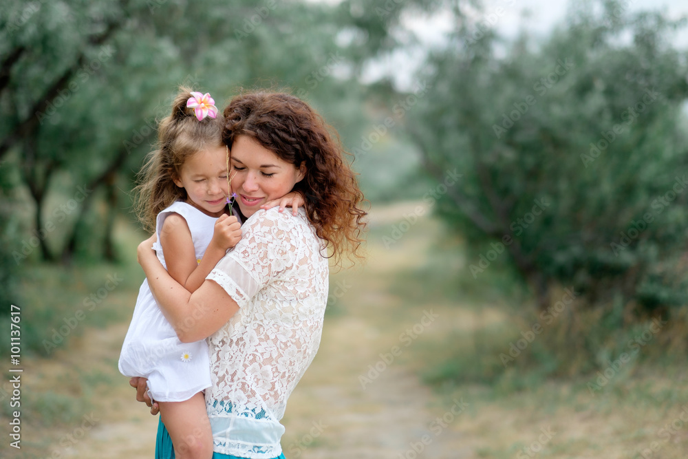 young mother with a baby in nature young mother with a baby in nature