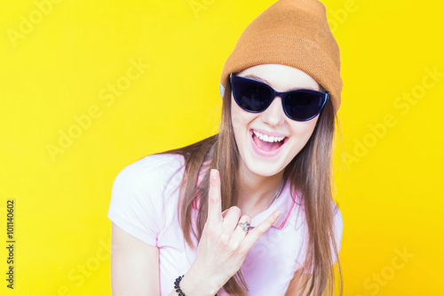 Funny teenage girl holding masquerade glasses for party