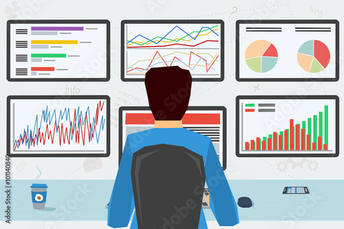 man at workplace with six monitors