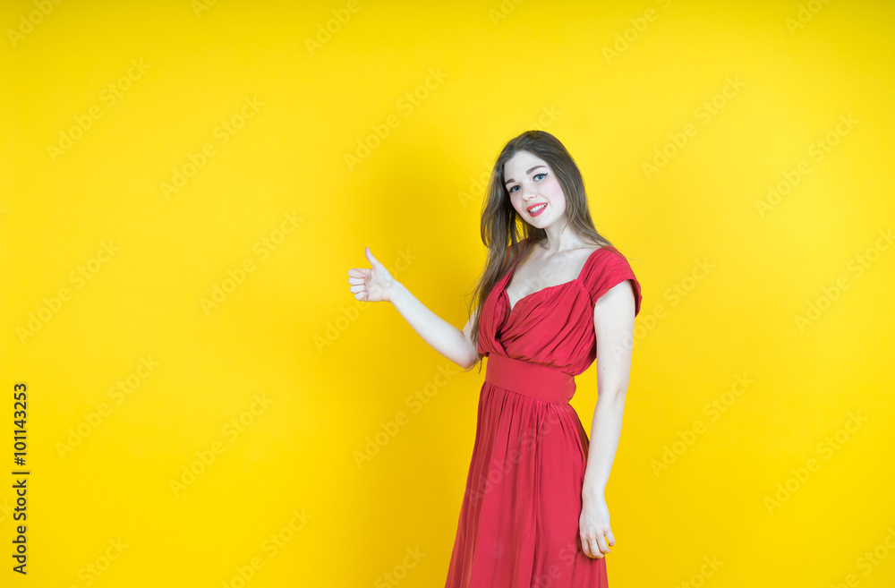 Success! Great job! Happy young woman showing her thumb up while standing against yellow background. Success! Great job! Happy young woman showing her thumb up while standing against yellow background.