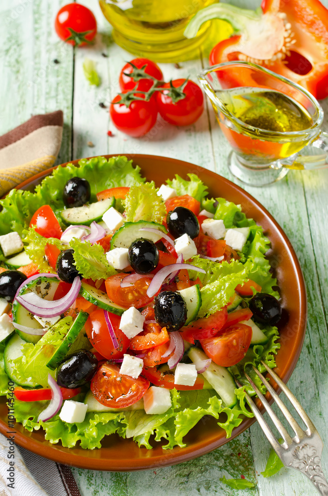 Greek salad with fresh vegetables, feta cheese and black olives Greek salad with fresh vegetables, feta cheese and black olives