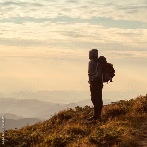 Traveler with backpack and mountain panorama