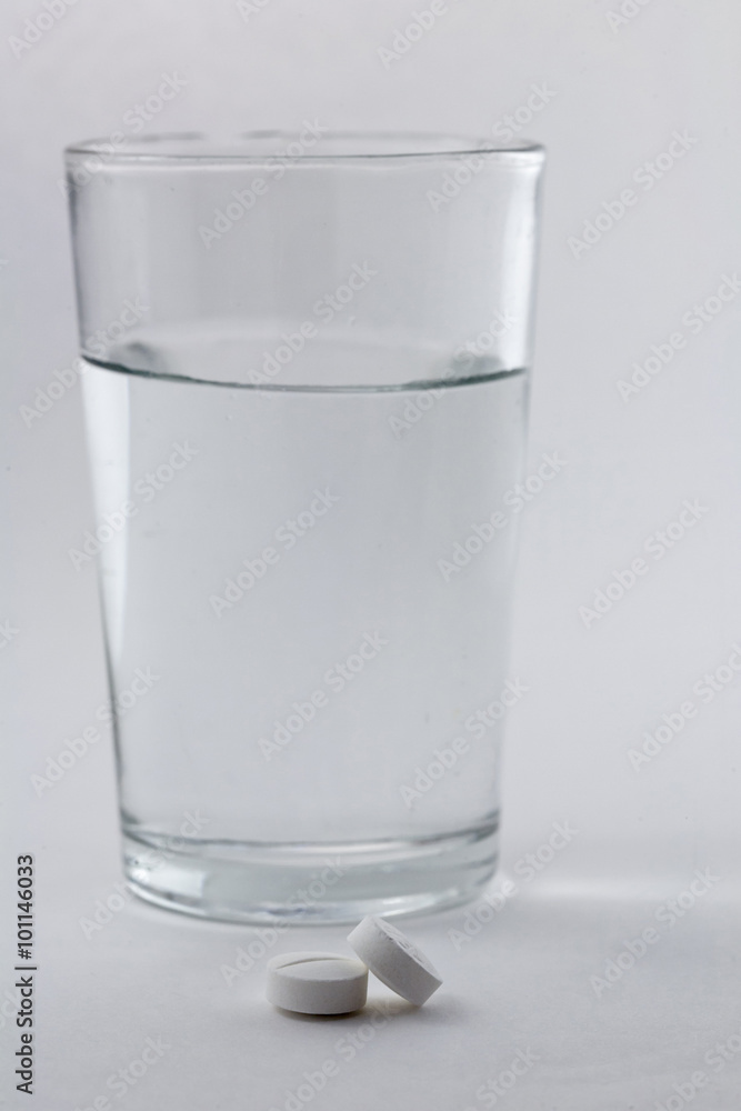 Glass of water and pills isolated on white background Glass of water and pills isolated on white background