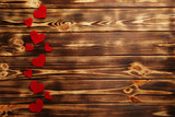 Red hearts on a brown wooden table