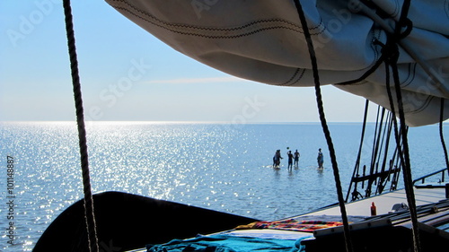 Sailing Vacation, people play volley on mudflat photo