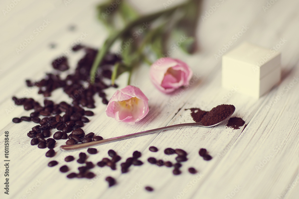 coffee beans, tulip flower and a box for an engagement ring lie on the table coffee beans, tulip flower and a box for an engagement ring lie on the table