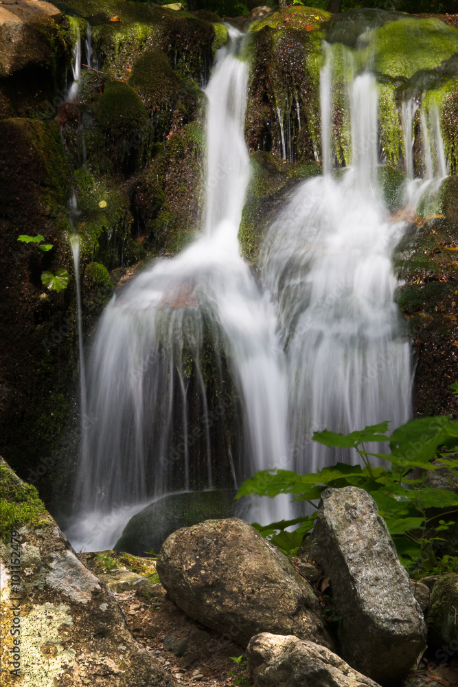 Obraz premium Small waterfall on a creek Ponikly in mountains Jeseniky