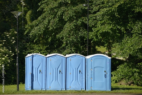 Old blue mobile toilet cabins.