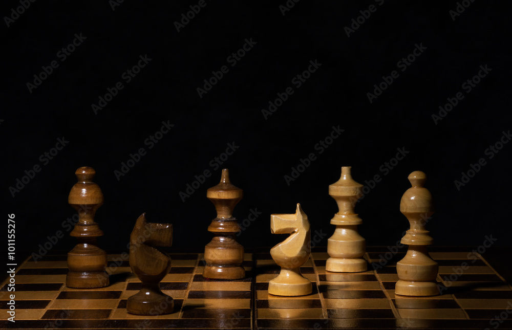 Chess pieces on a dark background Chess pieces on a dark background