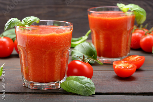 Fresh healthy tomato smoothie juice on wooden background