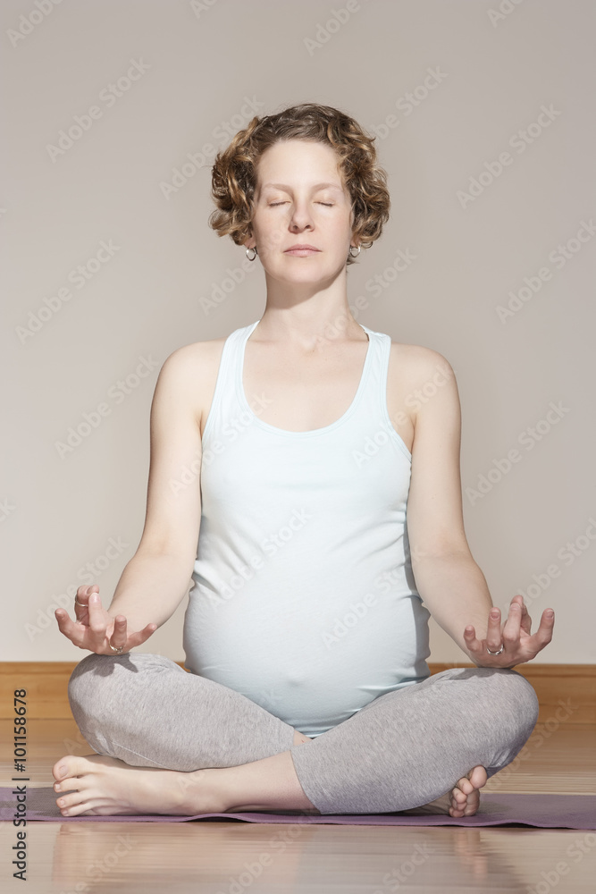 Caucasian pregnant woman meditating Caucasian pregnant woman meditating