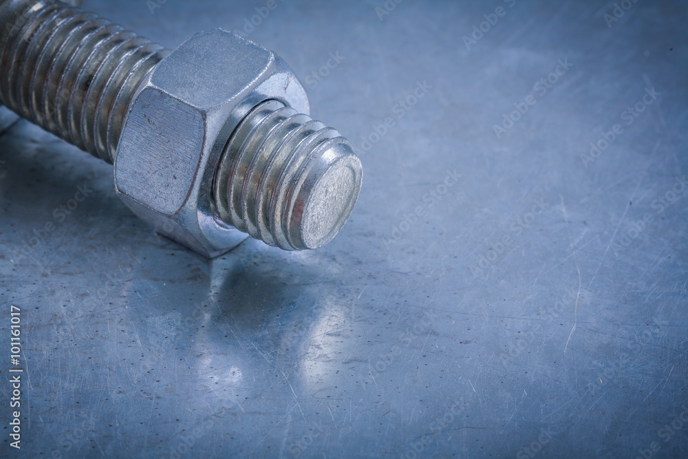 Threaded bolt detail and nut on metallic background construction Threaded bolt detail and nut on metallic background construction