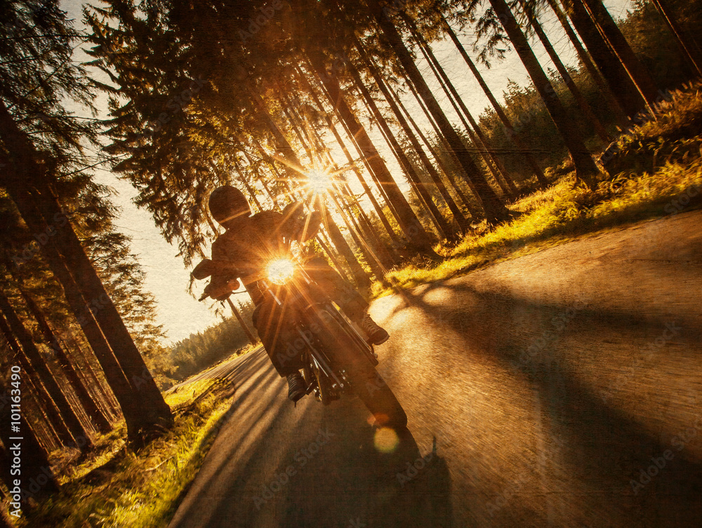 Fototapeta premium Man seat on the motorcycle on the forest road.