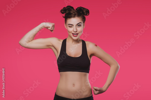 Fototapeta Naklejka Na Ścianę i Meble -  Slender young woman doing fitness on a pink background