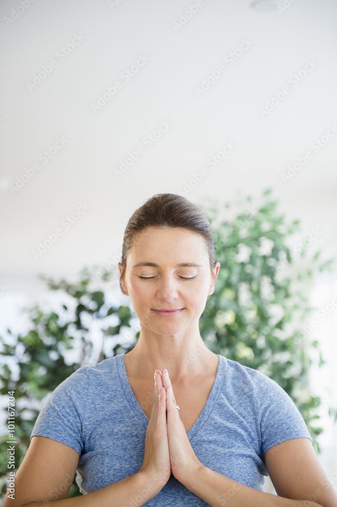 Serene Caucasian woman with hands in prayer position Serene Caucasian woman with hands in prayer position
