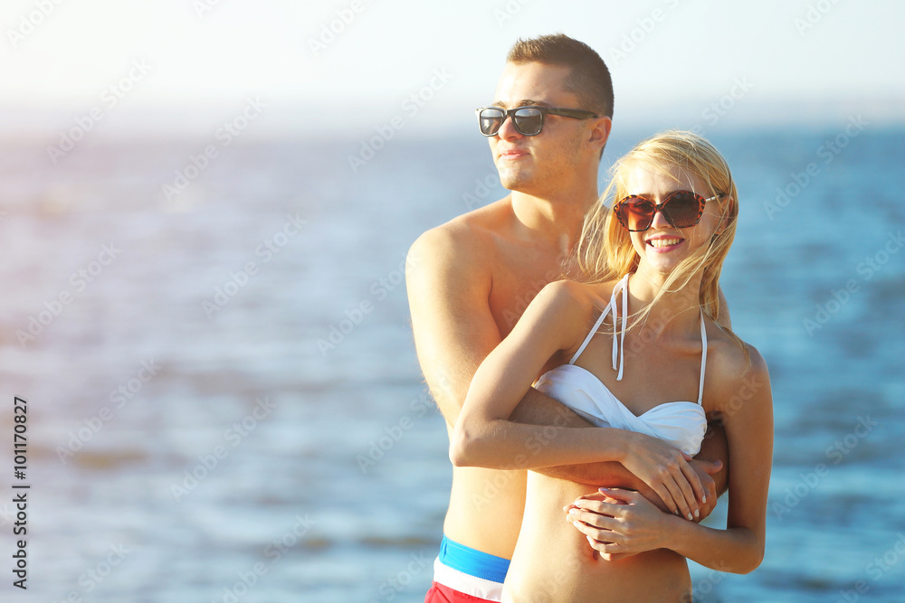 A hugging couple at the beach, outdoors A hugging couple at the beach, outdoors