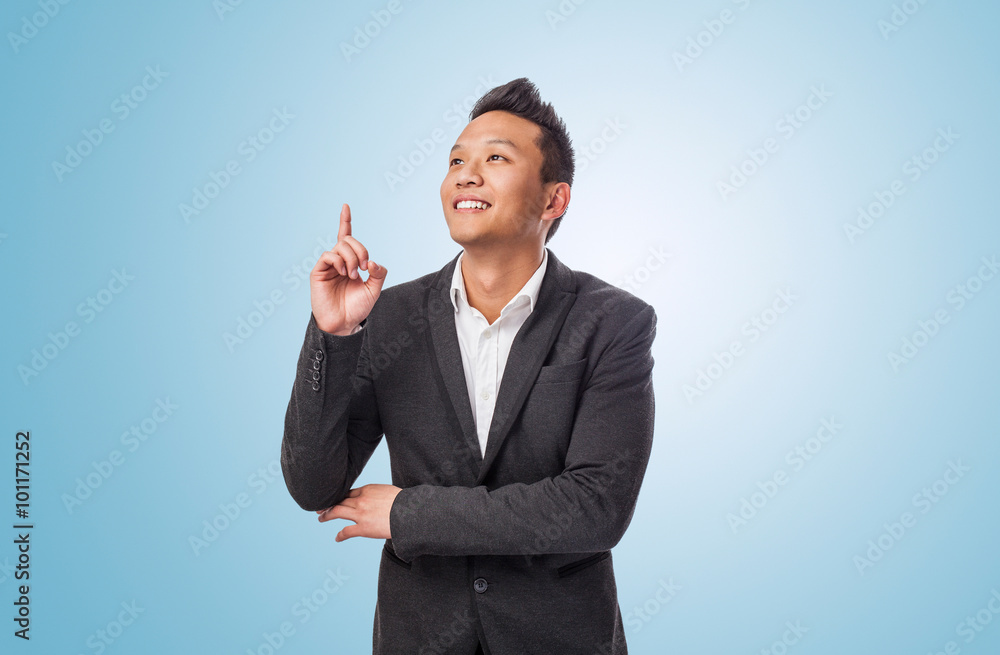 handsome young asian man pointing up with finger handsome young asian man pointing up with finger