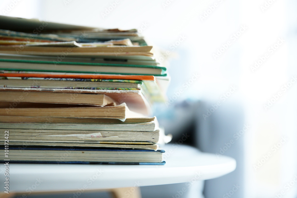 Pile of old books on white table Pile of old books on white table