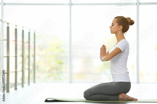 Young woman do yoga exercises