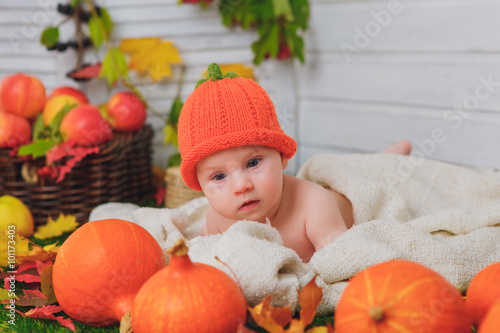 baby in the basket with pumpkins. autumn photo