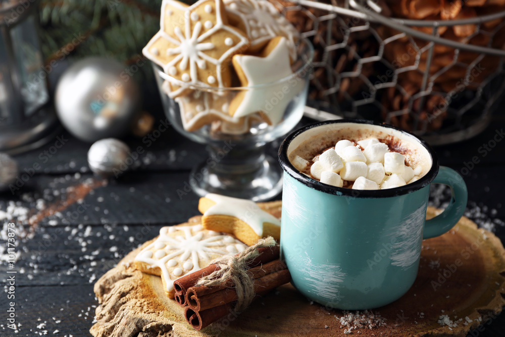 Mug of hot cacao with marshmallow and cookies on black table Mug of hot cacao with marshmallow and cookies on black table