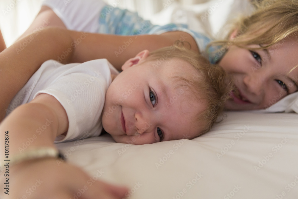 Caucasian siblings relaxing on sofa Caucasian siblings relaxing on sofa
