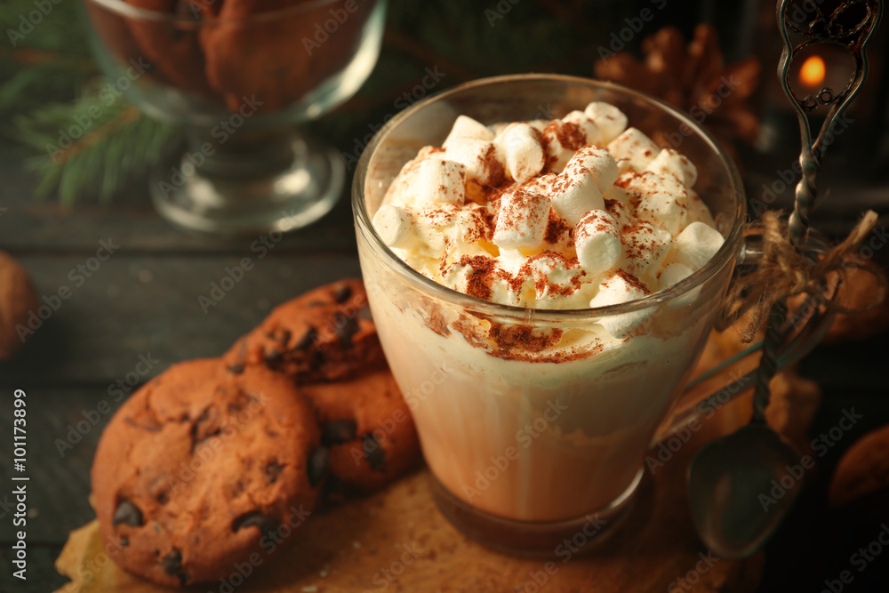 Cup of hot cacao with marshmallow and cookies on black table Cup of hot cacao with marshmallow and cookies on black table