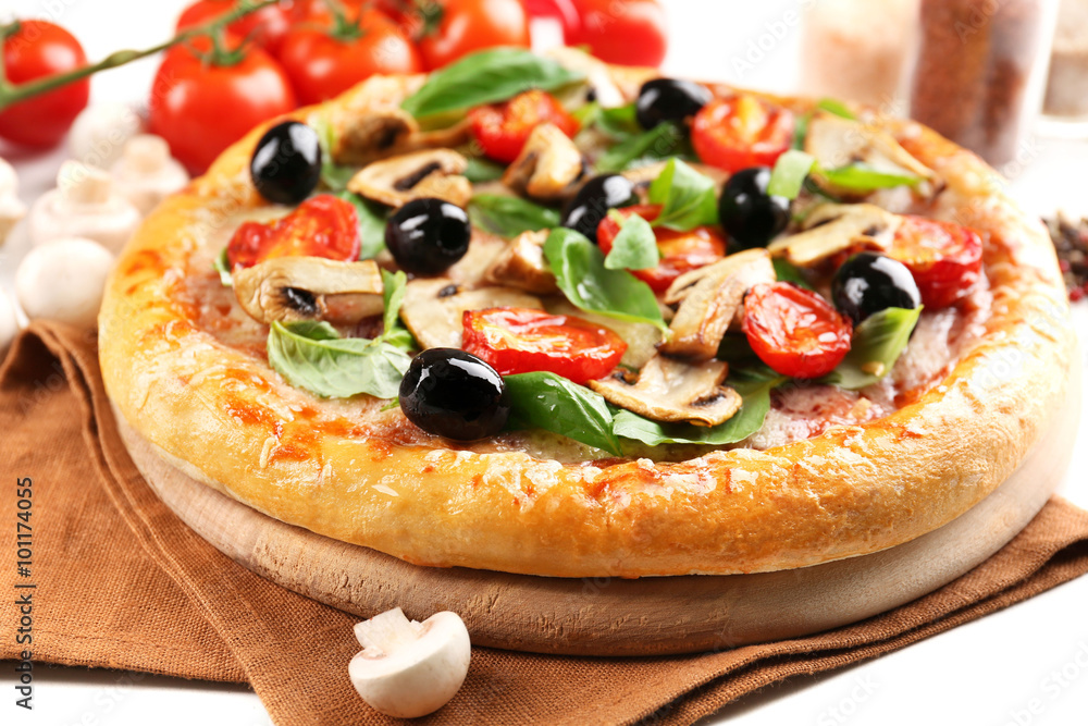 Delicious tasty pizza with vegetables on cutting board Delicious tasty pizza with vegetables on cutting board