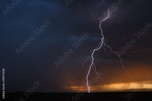 Epic lightning strike in front of warm sunset
