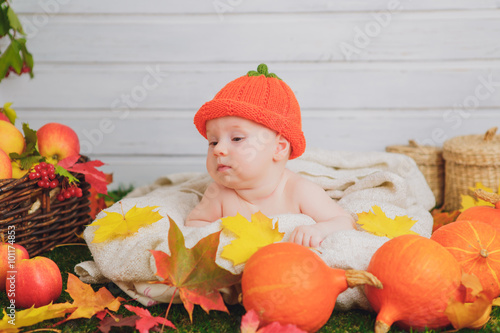 baby in the basket with pumpkins. autumn photo